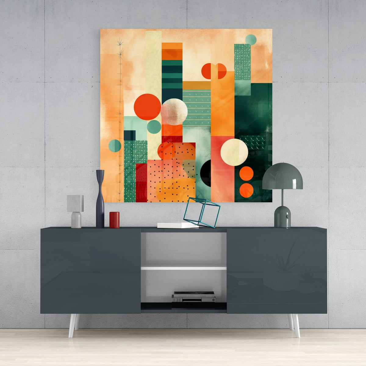 Peach and teal geometric glass wall art above a dark gray sideboard with a dome lamp and vase