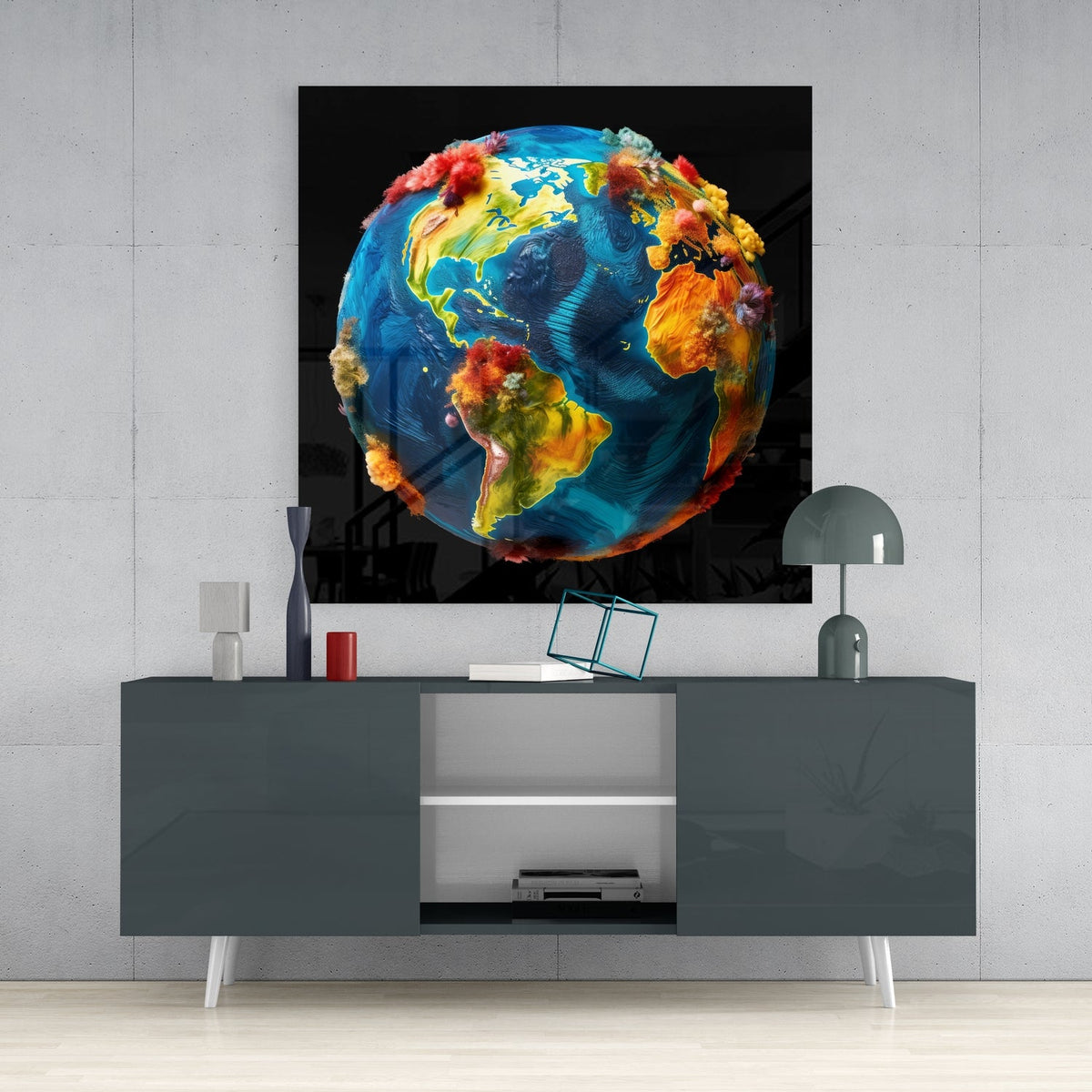 Colorful earth globe glass wall art above a dark gray sideboard with a dome lamp and vase