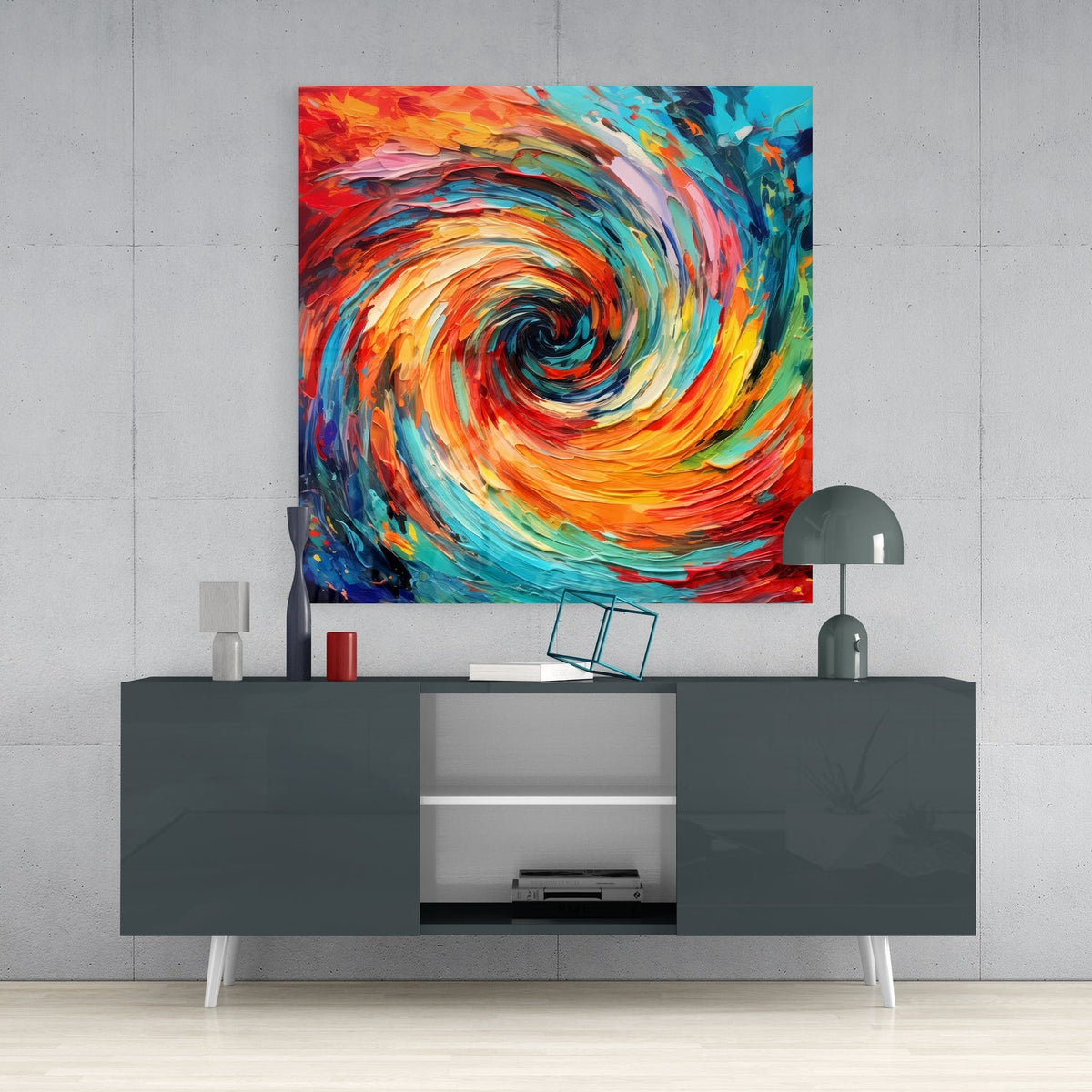 Orange and teal whirlpool glass wall art above a dark gray sideboard with a dome lamp and vase