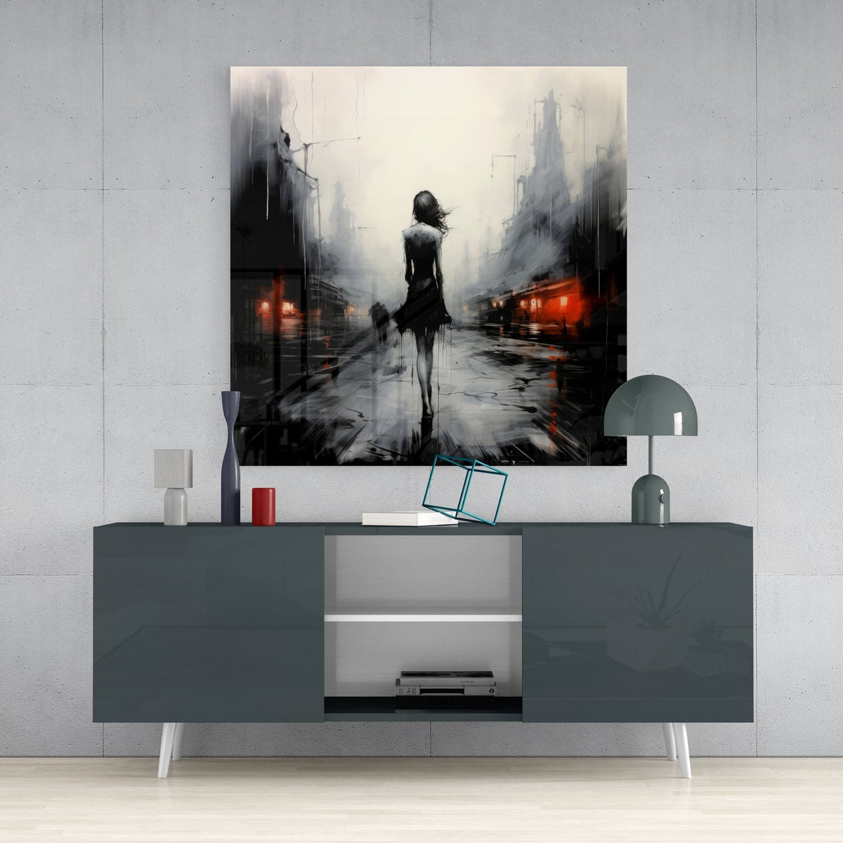Woman walking in the rain glass wall art on a light gray wall above a dark gray sideboard with a lamp