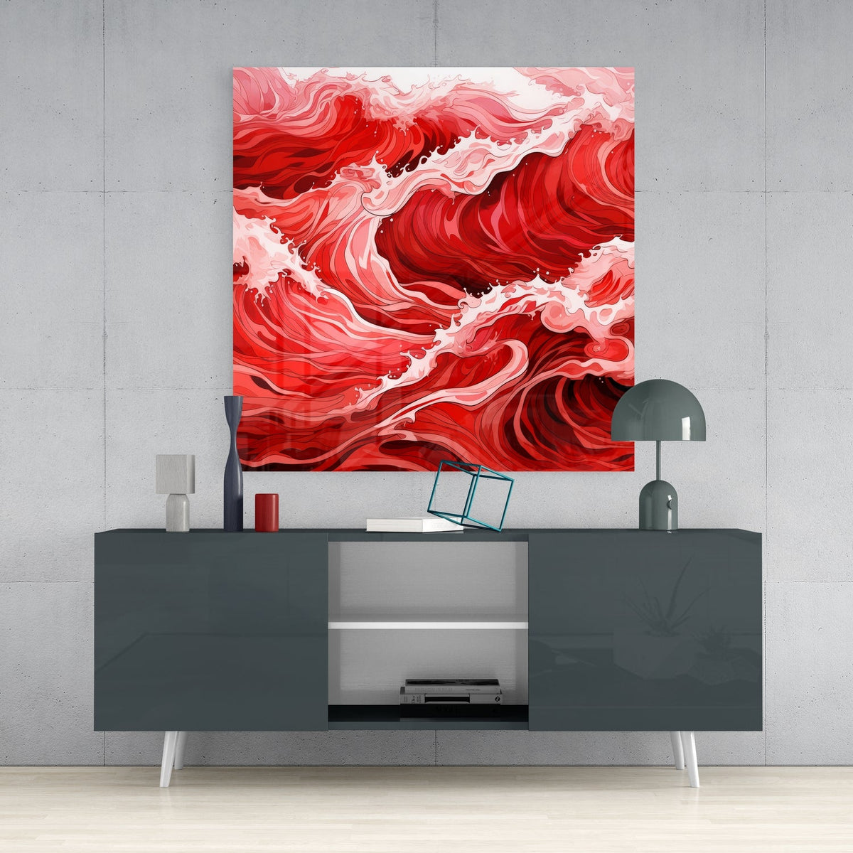 Red ocean waves glass wall art above a dark gray sideboard with a desk lamp