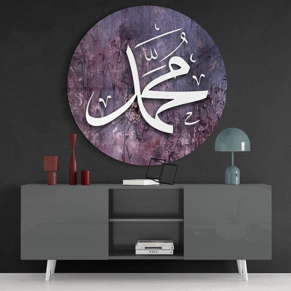 Purple Muhammad calligraphy round glass wall art above a gray sideboard with red vases on a dark wall