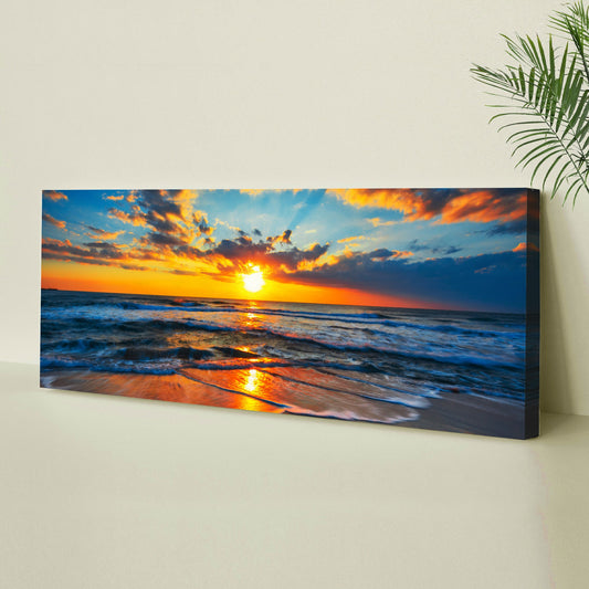 Orange sun on the ocean horizon canvas on a pale yellow wall, angled side view