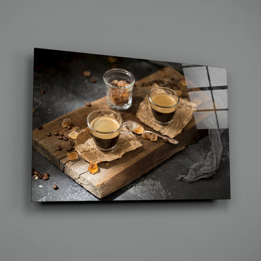 Two espresso shots on wood board glass wall art on a gray wall with a window reflection on the glossy surface