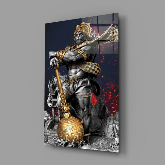 Hanuman with golden mace glass wall art on a gray wall, light reflecting off the glossy front