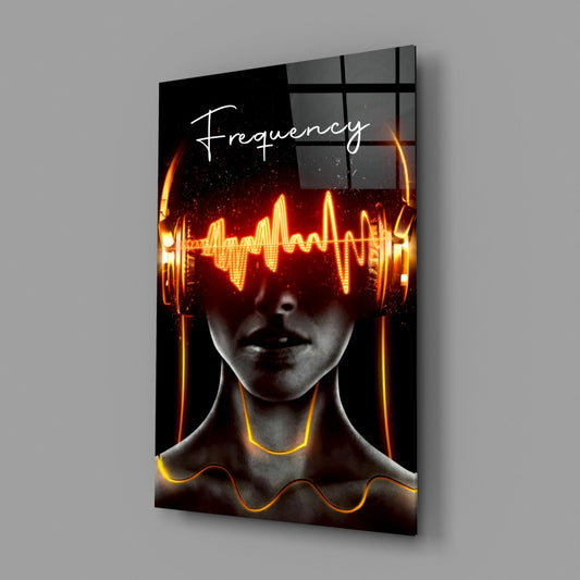 Glowing headphones portrait glass wall art hanging on a plain gray wall