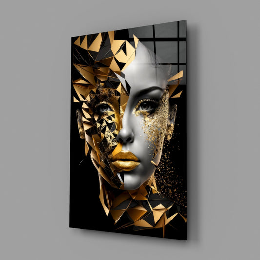 Gold geometric face glass wall art on a gray wall, light reflecting off the glossy front