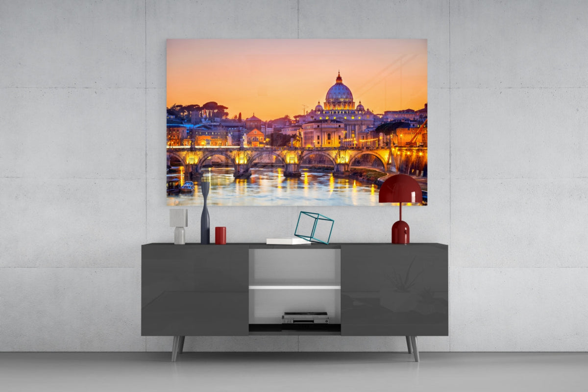 St. Peter's Basilica glass wall art above a gray sideboard with a red table lamp