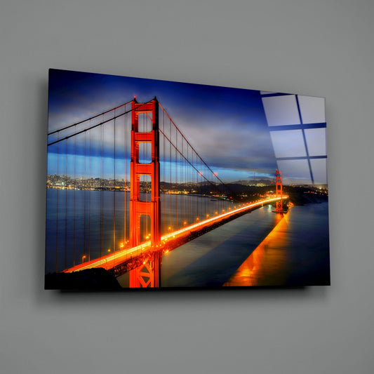 Golden Gate Bridge night glass wall art angled on a gray backdrop with light reflecting off the glossy front