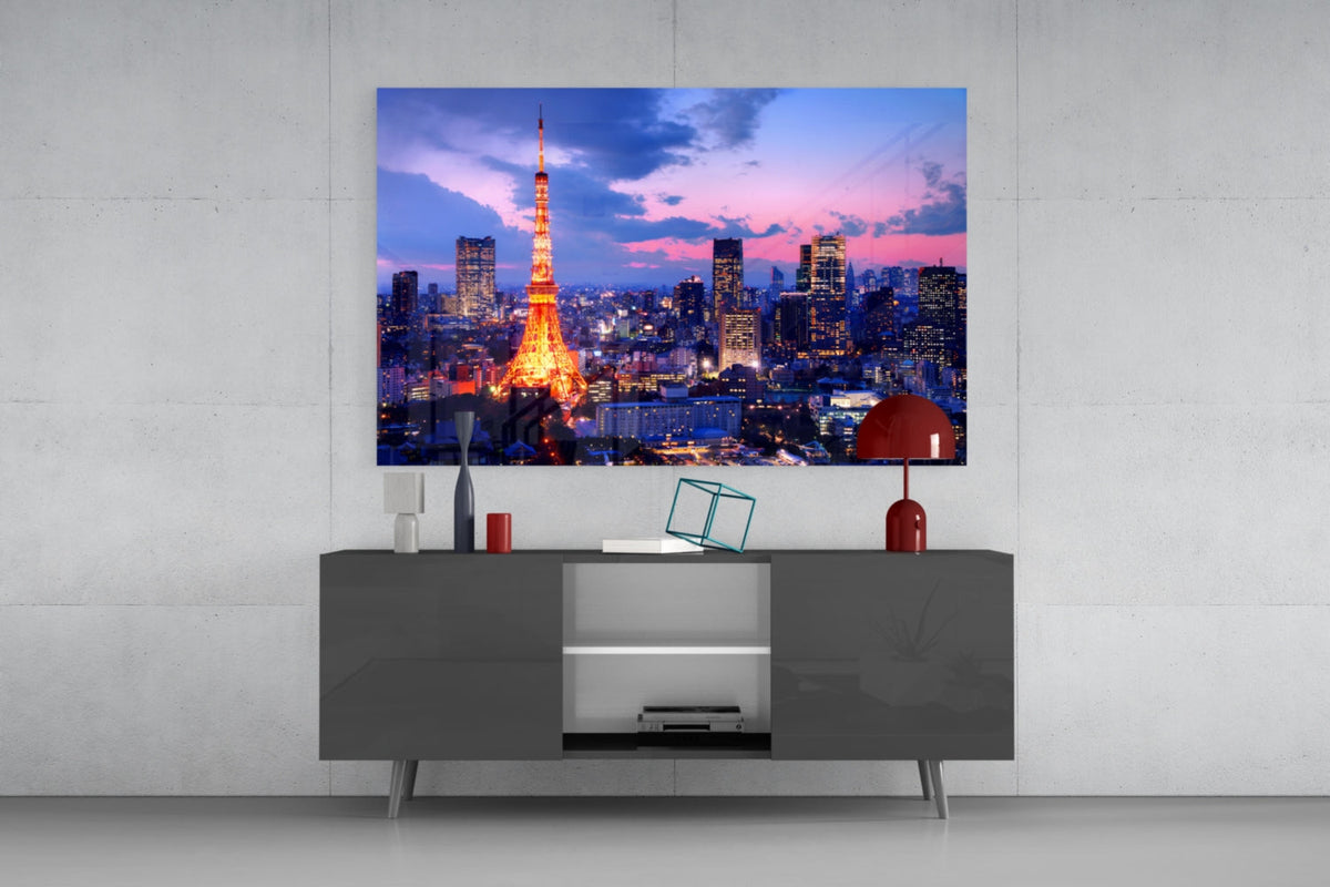 Tokyo skyline glass wall art above a gray sideboard with a red table lamp