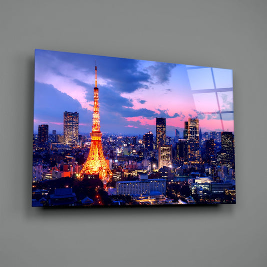 Tokyo skyline glass wall art on a plain gray wall, angled to show the glossy surface