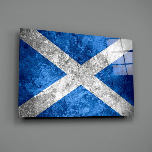 Weathered concrete Scotland flag glass wall art angled on a gray backdrop with light reflecting off the glossy front