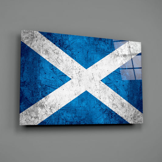 Scratched Scotland flag glass wall art angled on a gray backdrop with light reflecting off the glossy front
