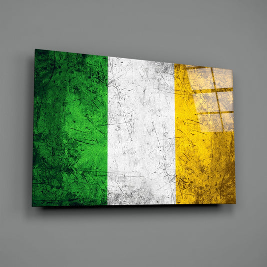 Scratched Ireland flag glass wall art angled on a gray backdrop with light reflecting off the glossy front