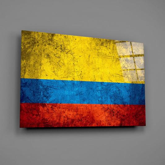 Weathered Colombia flag glass wall art on a gray wall with a window reflection across the glossy glass