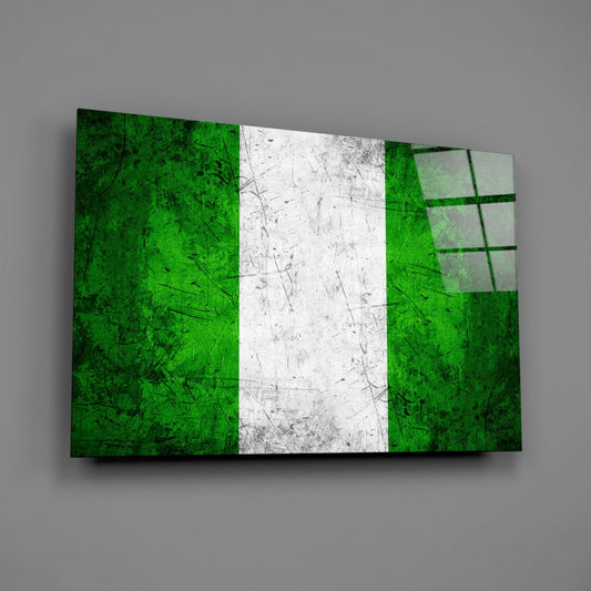 Weathered Nigeria flag glass wall art on a gray wall with a window reflection on the glass