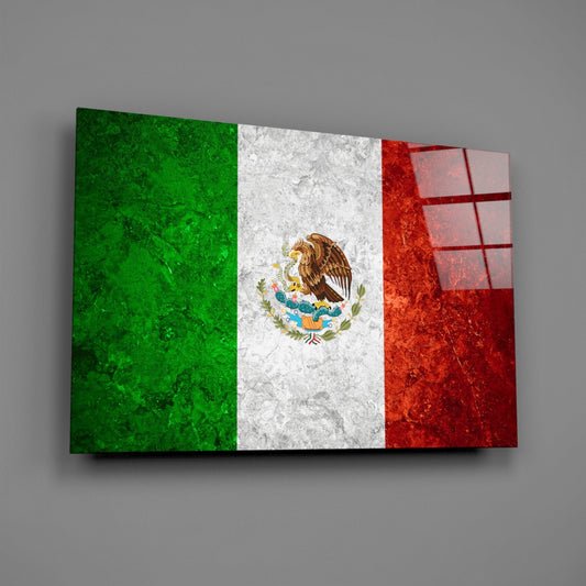 Weathered Mexico flag glass wall art on a gray wall with a window reflection on the glass