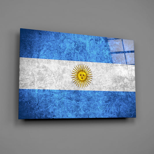 Weathered Argentina flag glass wall art on a gray wall with a window reflection across the glossy glass