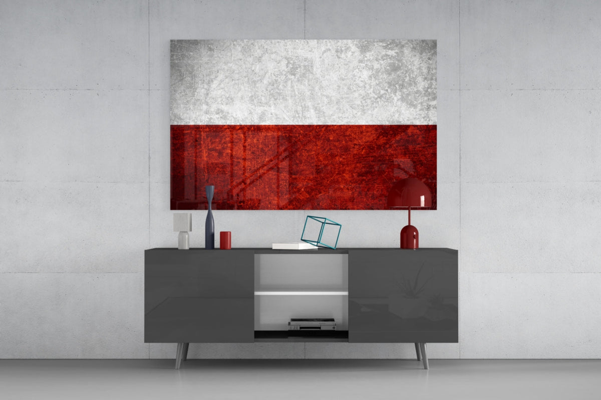 Rustic grunge Poland flag glass wall art above a gray sideboard with a red lamp on a pale concrete wall