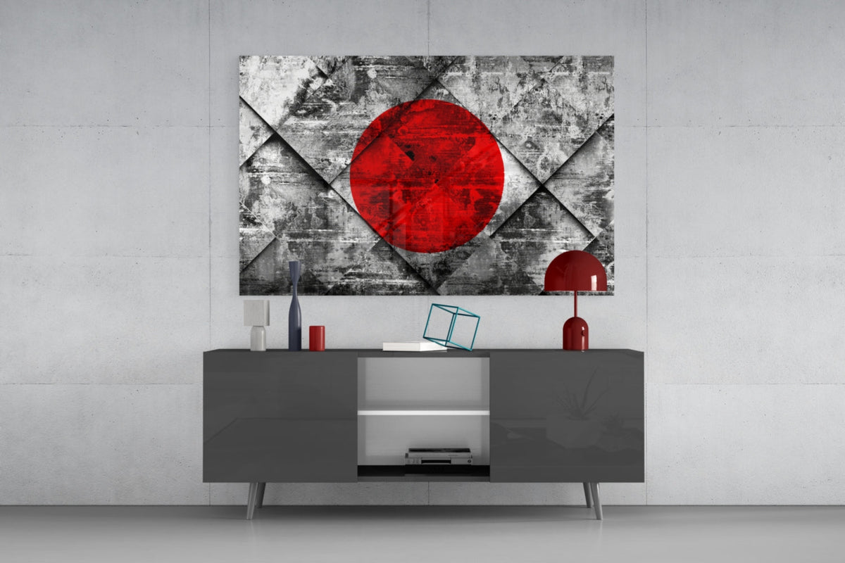 Japan flag red sun on gray diamond glass wall art above a dark gray media console with a red table lamp