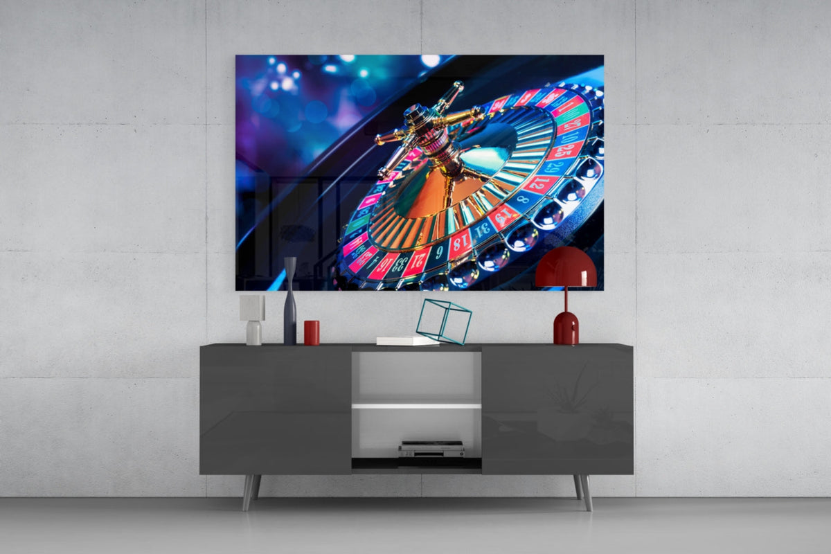 Spinning roulette wheel glass wall art above a gray sideboard with a red lamp