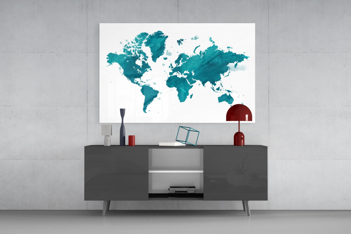 Teal watercolor world map glass wall art above a dark gray sideboard with a red lamp on a concrete wall