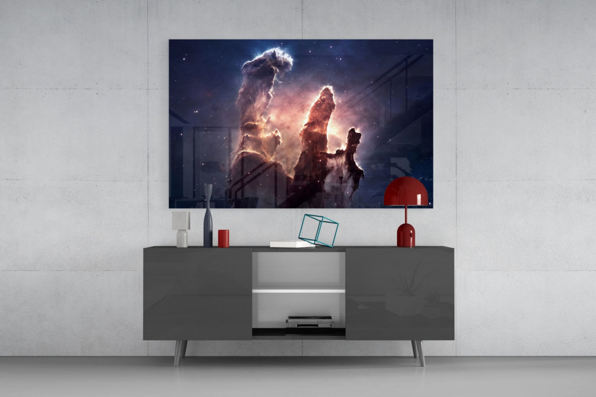 Nebula pillars glass wall art above a dark gray sideboard with a red lamp on a concrete wall