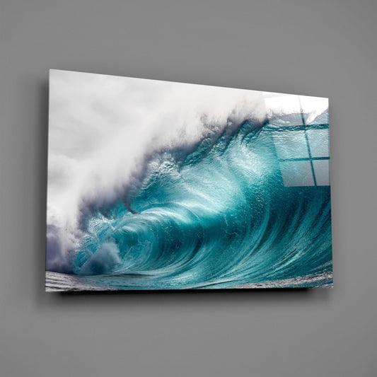 Teal wave under a pale sky glass wall art on a gray wall with light reflecting off the glossy front