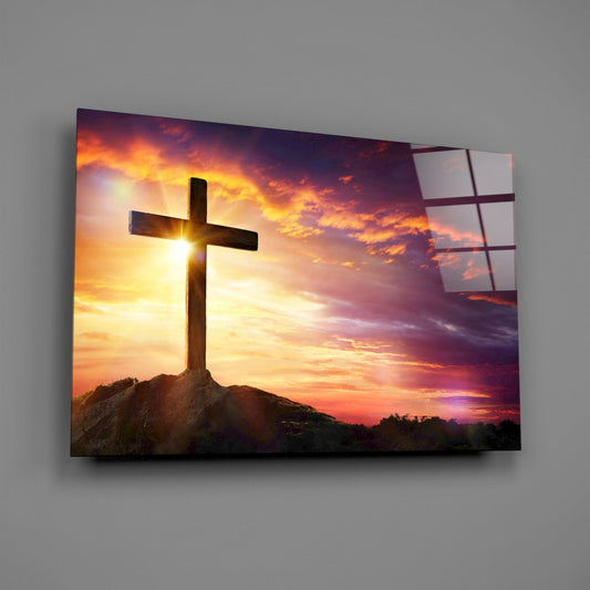 Wooden cross at sunset glass wall art on a gray wall with a soft window reflection