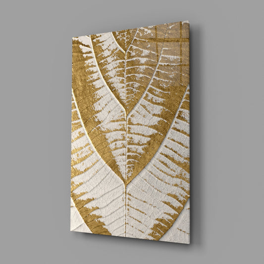 Golden fern leaf on cream glass wall art on a gray wall with light reflecting off the glossy front