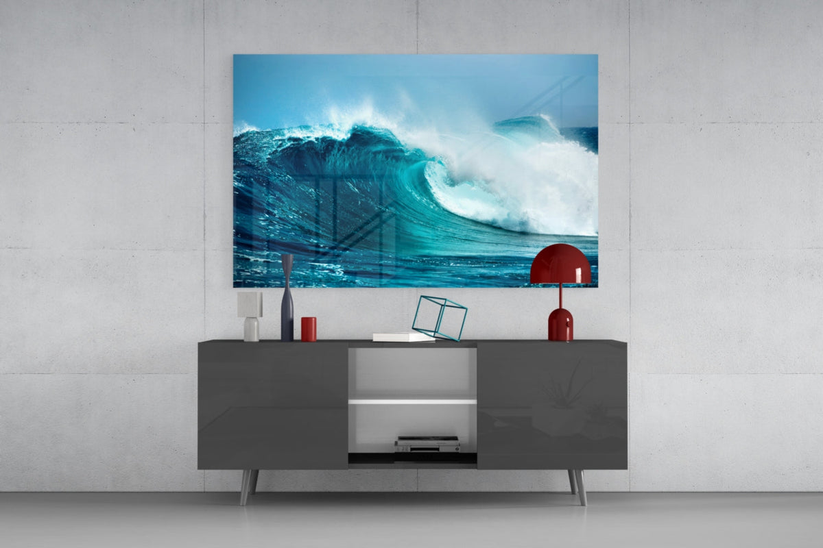 Turquoise curling wave glass wall art above a dark gray sideboard with a red table lamp