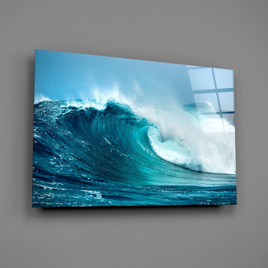 Turquoise curling wave glass wall art on a gray wall with light reflecting off the glossy front