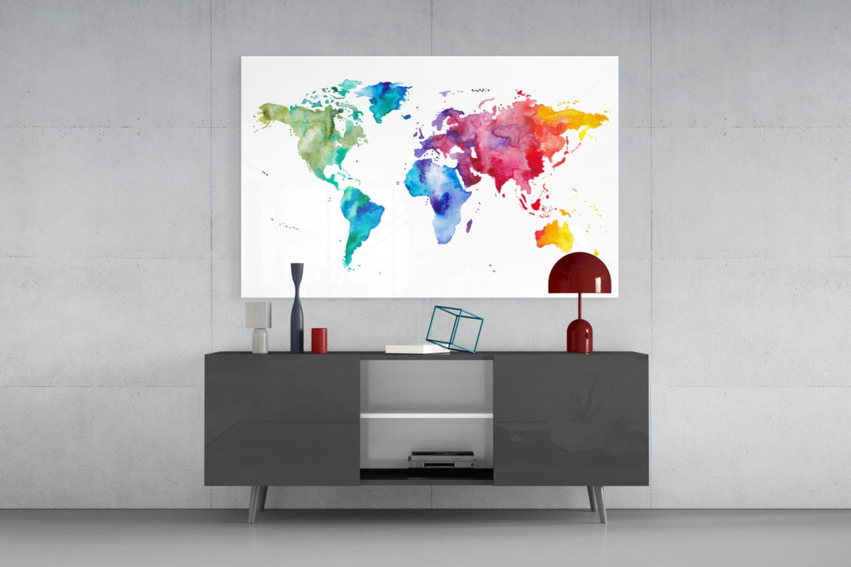 Rainbow watercolor world map glass wall art above a dark gray sideboard with a red lamp on a concrete wall
