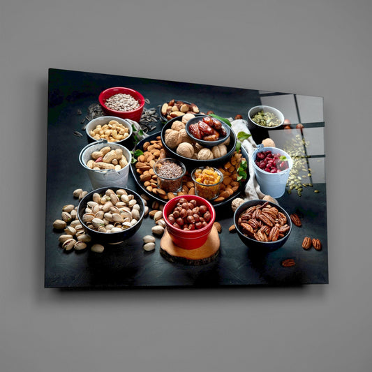 Nuts and dried fruit glass wall art hanging on a plain gray wall