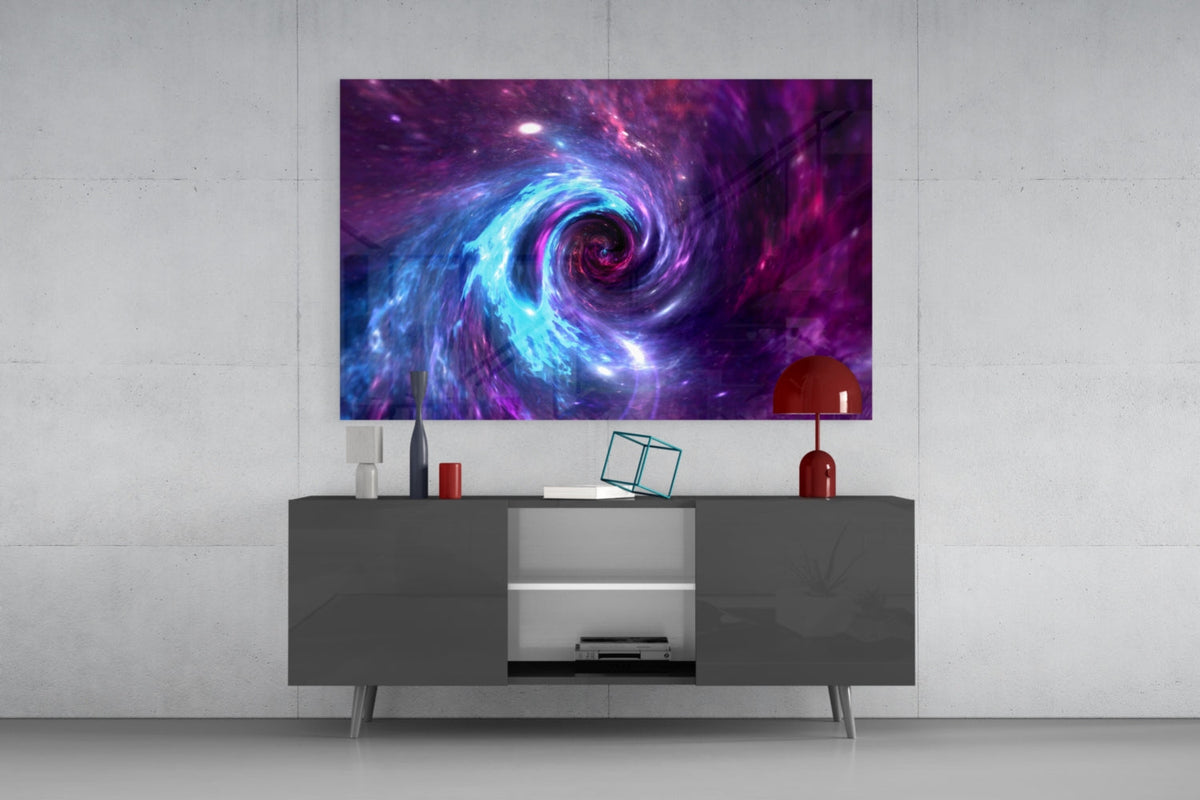 Blue and purple space vortex glass wall art above a dark gray sideboard with a red lamp on a concrete wall