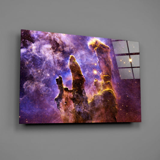 Lilac and gold nebula pillars glass wall art on a gray wall, light reflecting off the glossy front