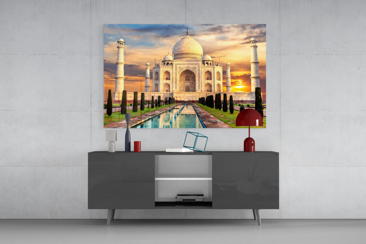 Taj Mahal glass wall art above a gray sideboard with a red table lamp