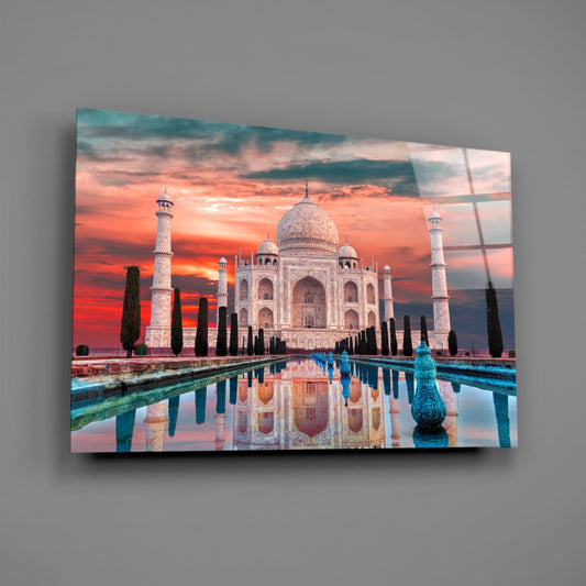 Taj Mahal crimson sky glass wall art on a gray wall, light catching the glossy front