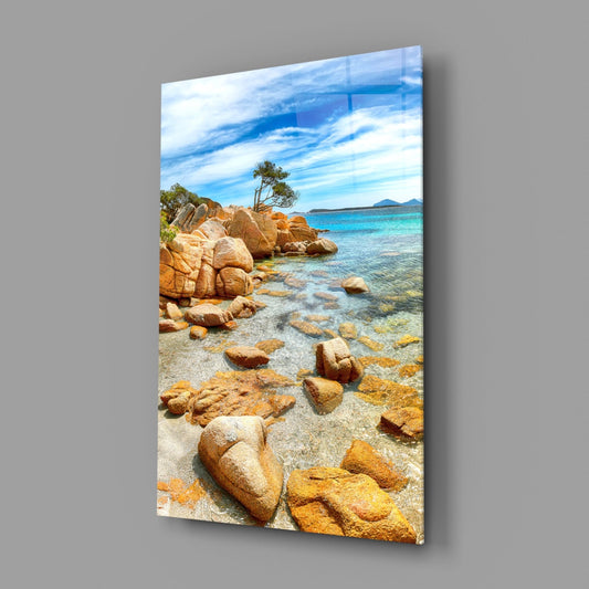 Turquoise cove glass wall art on a gray wall, light reflecting off the glossy front
