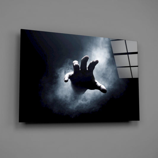 Reaching hand in smoke glass wall art hanging on a plain gray wall