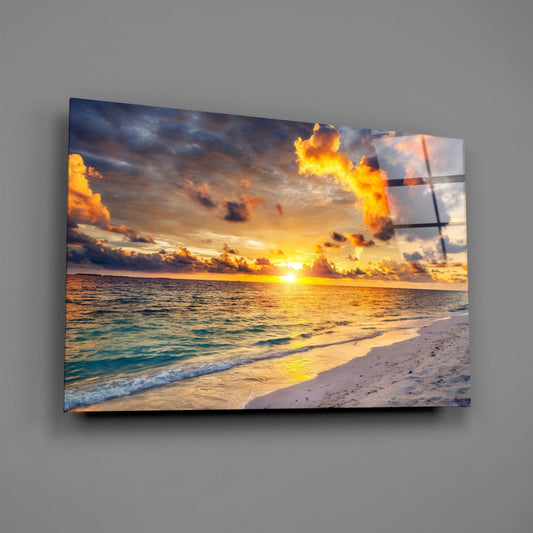 Fiery sunset beach glass wall art on a gray wall, light reflecting off the glossy front