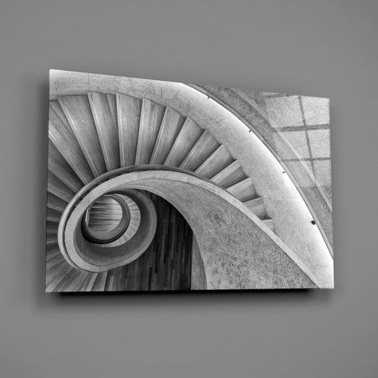 Spiral staircase glass wall art on a gray wall, light catching the glossy front