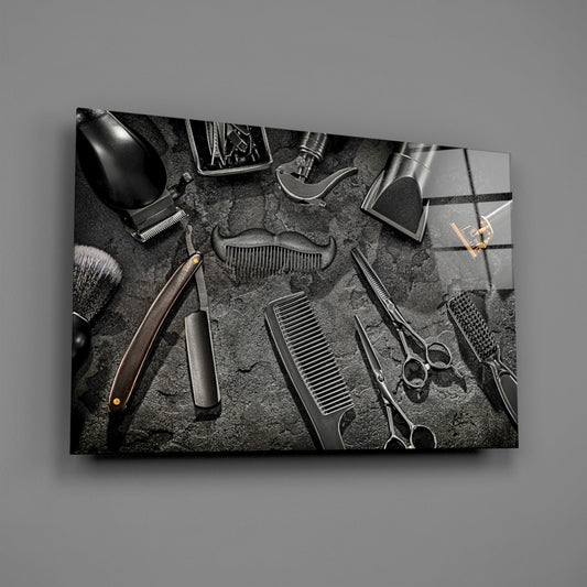 Barber tools glass wall art on a gray wall, light reflecting off the glossy front