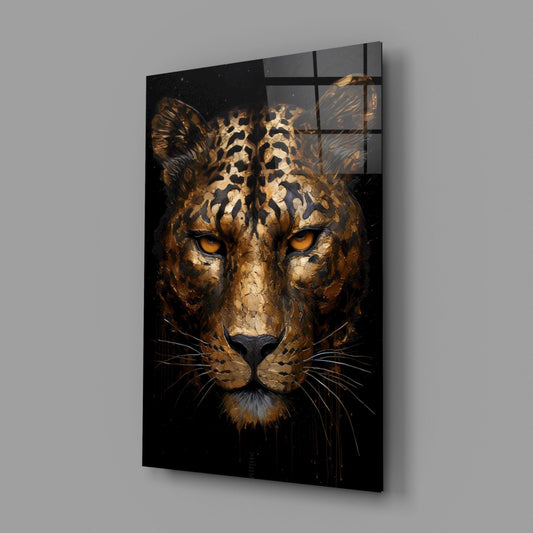Golden leopard face glass wall art on a gray wall, light reflecting off the glossy front
