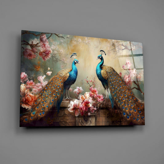 Peacock pair with blossoms glass wall art angled on a plain gray wall