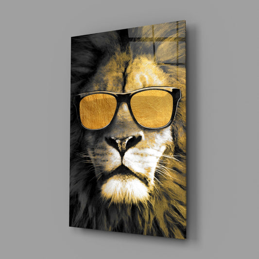 Lion in gold sunglasses glass wall art on a gray wall, light reflecting off the glossy front