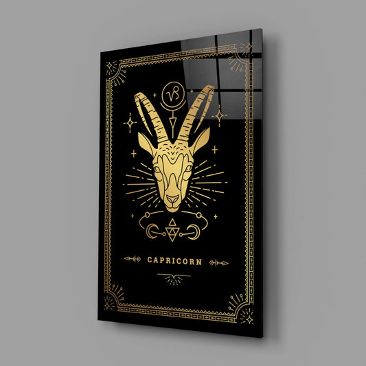 Capricorn zodiac glass wall art on a gray wall, light reflecting off the glossy black front