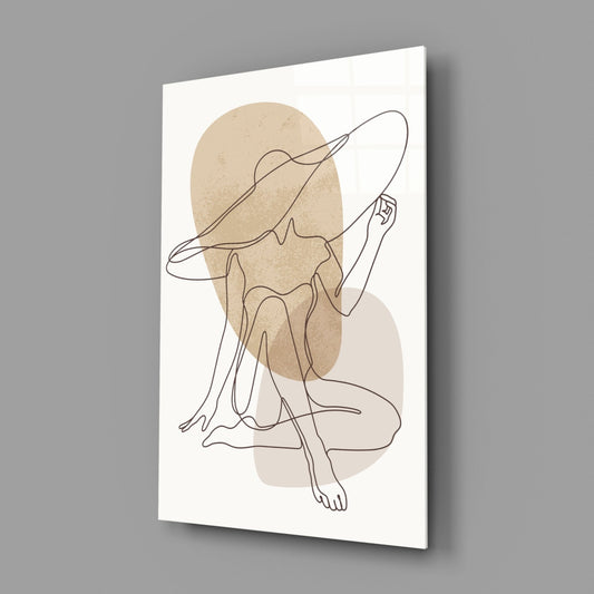 Seated woman line art glass wall art on a gray wall, light reflecting off the glossy front