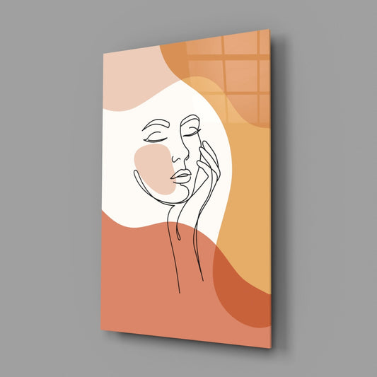 Terracotta line art face glass wall art on a gray wall, light reflecting off the glossy front