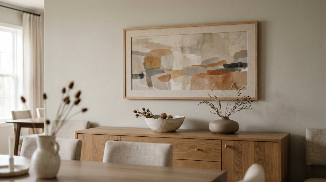 A wide landscape-orientation framed abstract print above a long credenza, an example of horizontal art matched to wide furniture